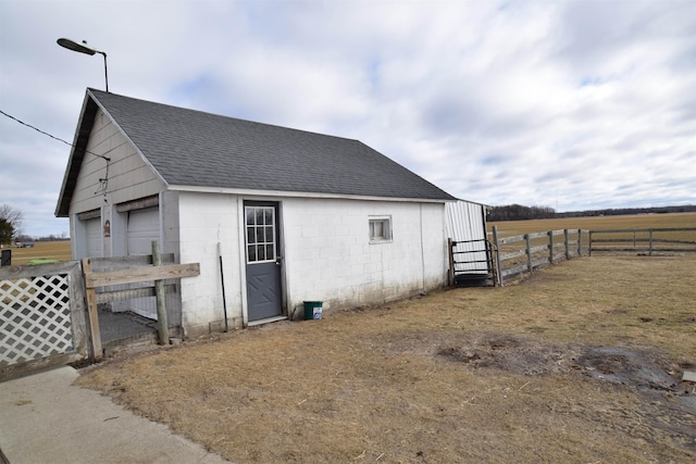 view of outdoor structure with an outbuilding and fence