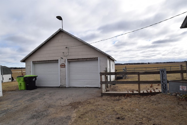 detached garage featuring fence