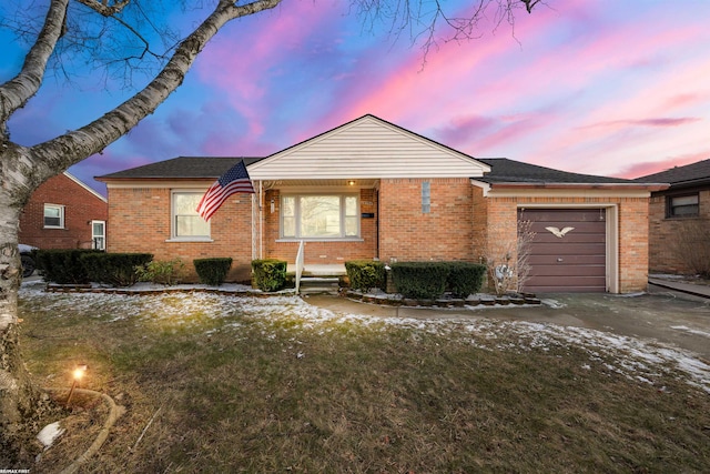 ranch-style home featuring brick siding, driveway, and an attached garage