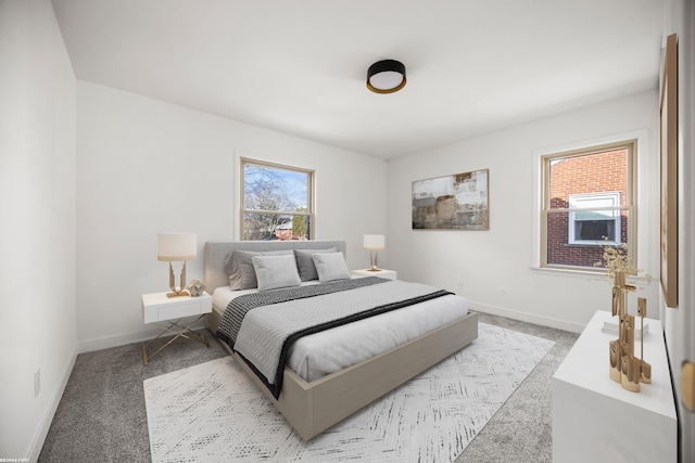 bedroom featuring light carpet and baseboards