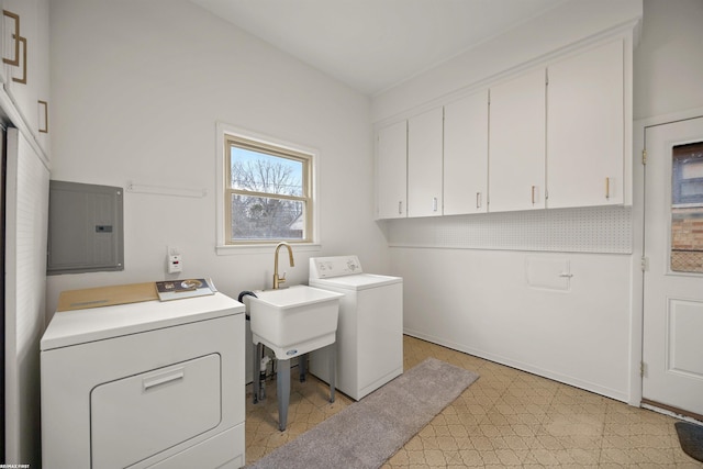 clothes washing area featuring light floors, cabinet space, a sink, separate washer and dryer, and electric panel