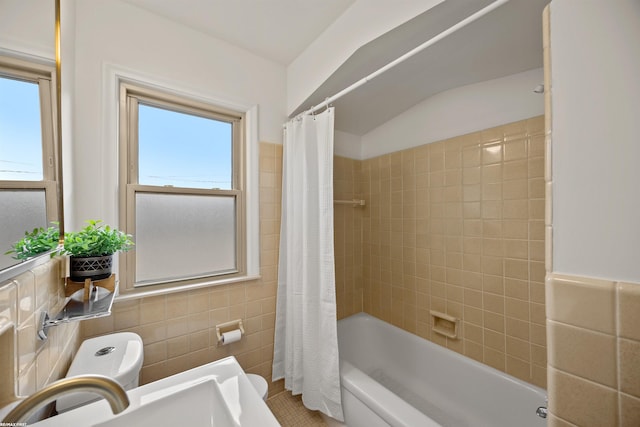 full bathroom featuring a sink, tile walls, toilet, and shower / bath combo with shower curtain