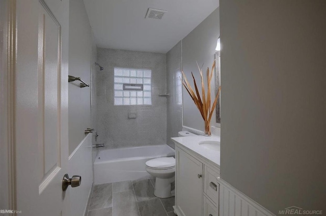 full bath featuring visible vents, toilet, washtub / shower combination, vanity, and tile patterned flooring