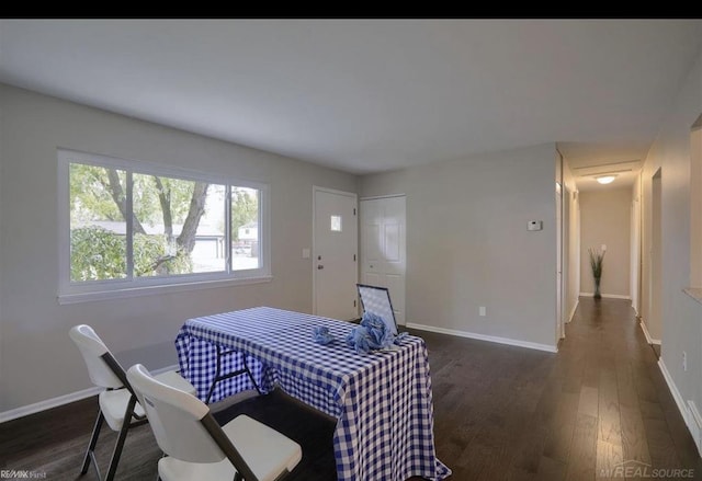 dining room with dark wood-style floors and baseboards