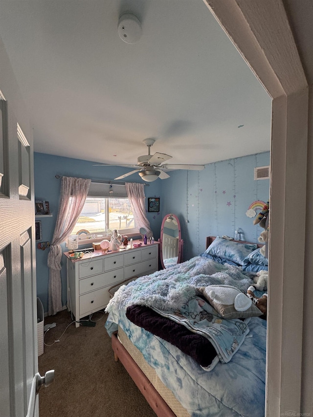 bedroom with dark colored carpet, visible vents, and ceiling fan