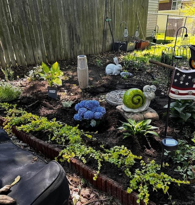 exterior details with fence and a vegetable garden