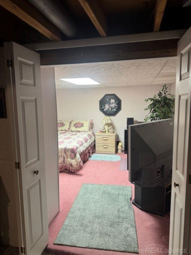 carpeted bedroom with a drop ceiling