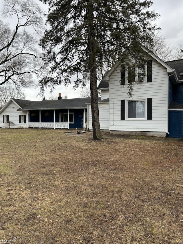 back of property featuring a lawn and cooling unit