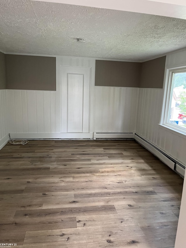 spare room featuring a textured ceiling and wood finished floors