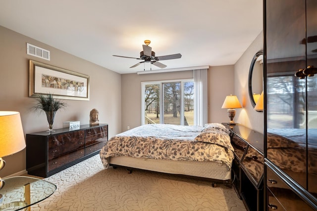 bedroom with access to exterior, carpet, visible vents, and a ceiling fan