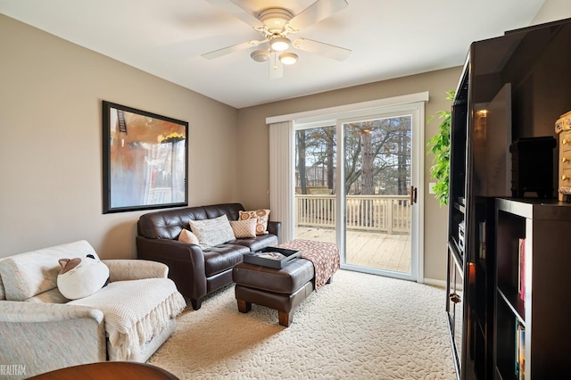 living area with carpet floors and ceiling fan