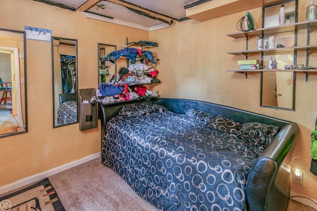 bedroom featuring carpet floors and baseboards