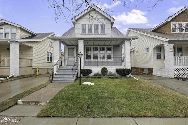 bungalow-style house with covered porch and a front lawn