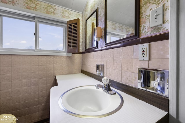 bathroom featuring wallpapered walls, tile walls, and a wealth of natural light