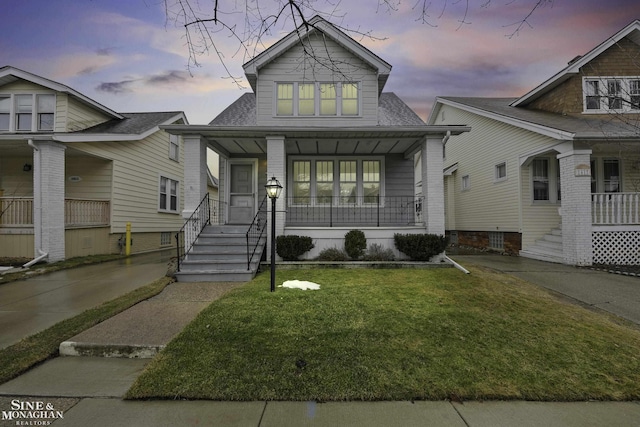 view of front facade with a porch and a yard