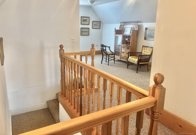 stairway with carpet, baseboards, and vaulted ceiling