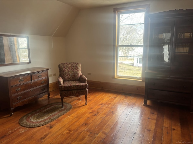 sitting room with lofted ceiling, baseboards, and hardwood / wood-style floors