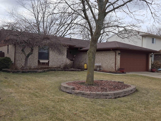 view of front of home featuring an attached garage, brick siding, driveway, and a front yard