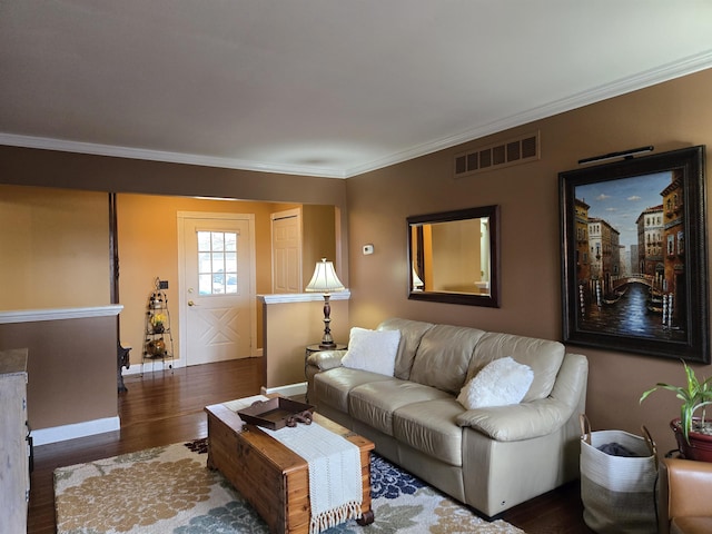 living area featuring visible vents, crown molding, baseboards, and wood finished floors