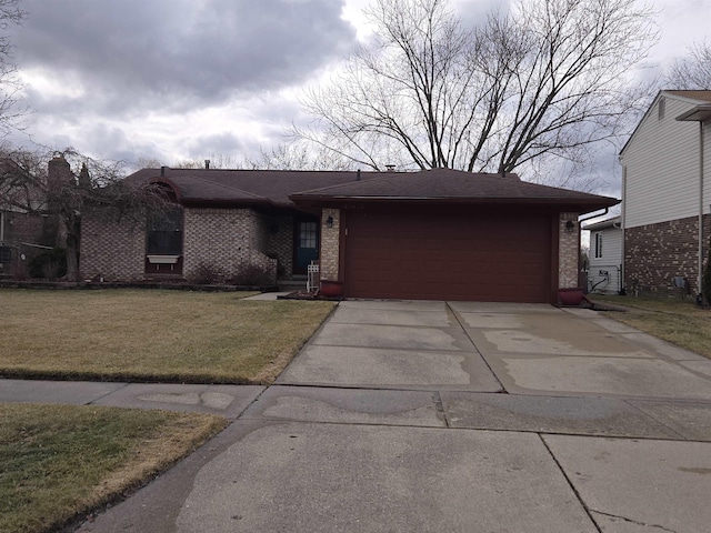 view of front of home featuring a garage, concrete driveway, roof with shingles, a front lawn, and brick siding