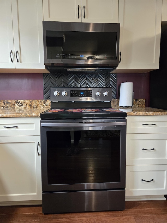 kitchen featuring appliances with stainless steel finishes, dark wood finished floors, and white cabinets