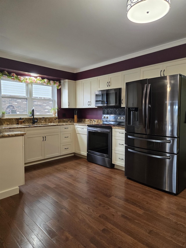 kitchen featuring dark wood-style floors, electric range, white cabinets, a sink, and black fridge