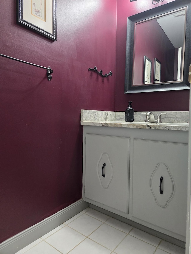 bathroom featuring tile patterned flooring, vanity, and baseboards