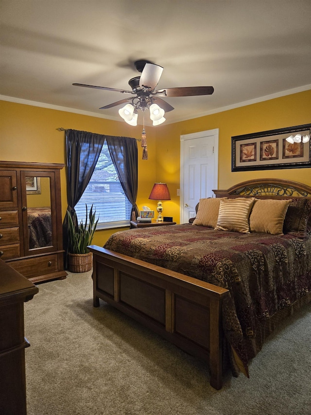 carpeted bedroom featuring ceiling fan and ornamental molding