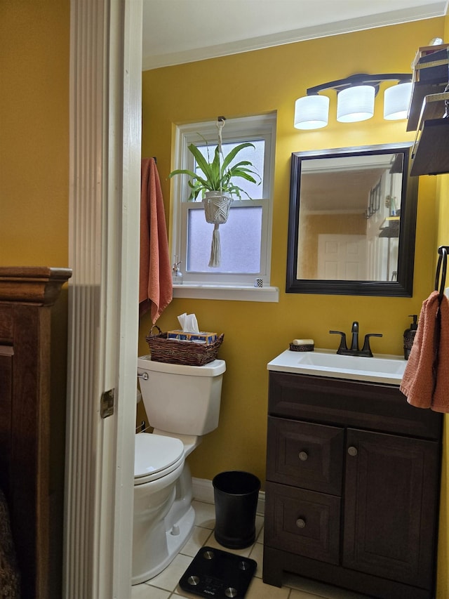 half bath featuring toilet, tile patterned flooring, baseboards, and vanity