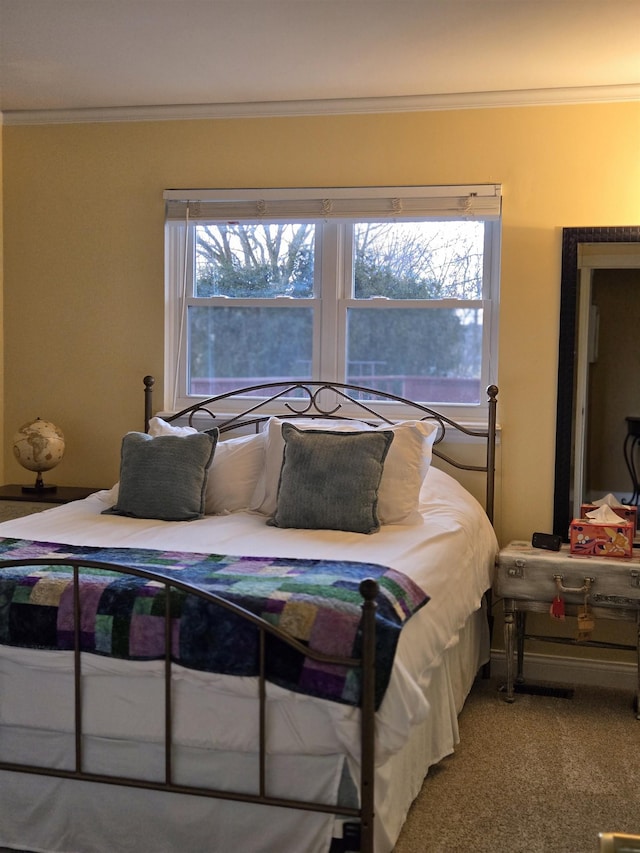 bedroom featuring carpet flooring and crown molding