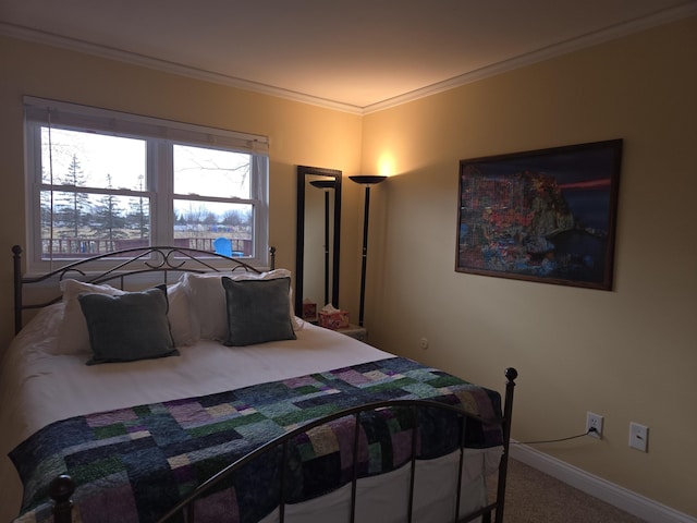 carpeted bedroom featuring baseboards and crown molding