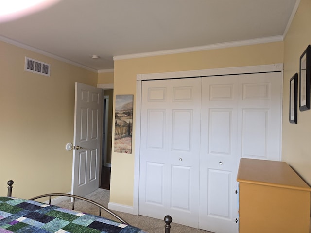 unfurnished bedroom with ornamental molding, carpet, a closet, and visible vents