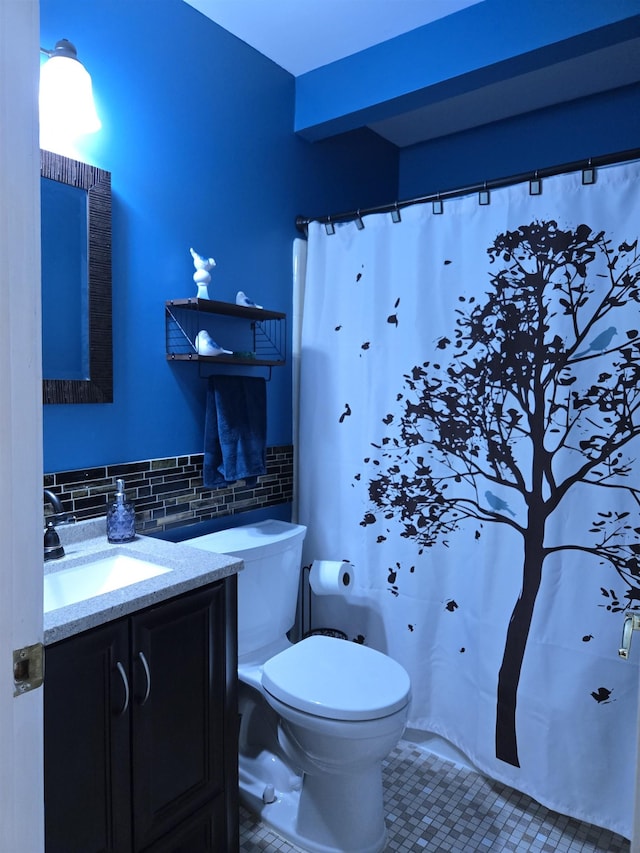 bathroom featuring tile walls, curtained shower, toilet, vanity, and tile patterned flooring