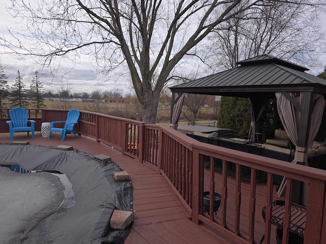 wooden terrace featuring a gazebo