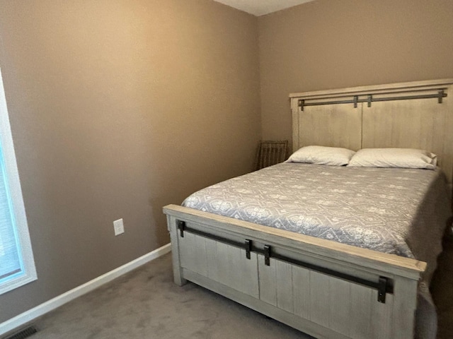 bedroom featuring carpet flooring, visible vents, and baseboards