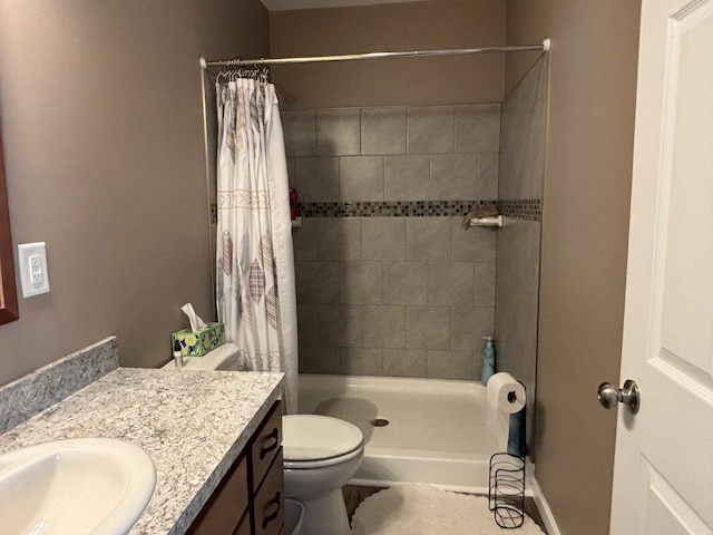 full bath with toilet, a stall shower, vanity, and baseboards