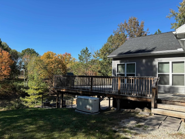 exterior space with a wooden deck, roof with shingles, and a yard