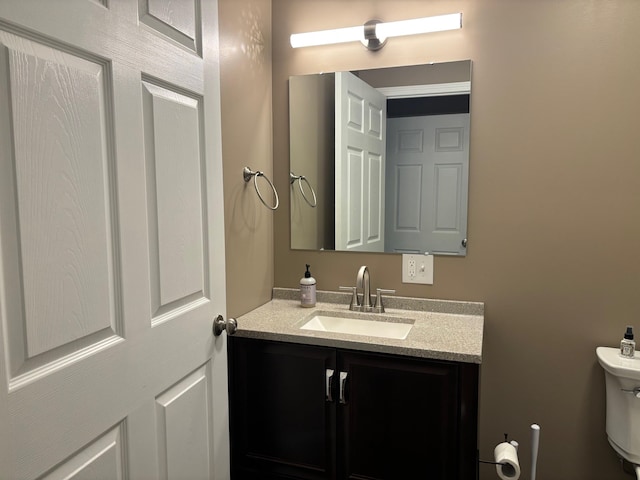 half bath with vanity and toilet