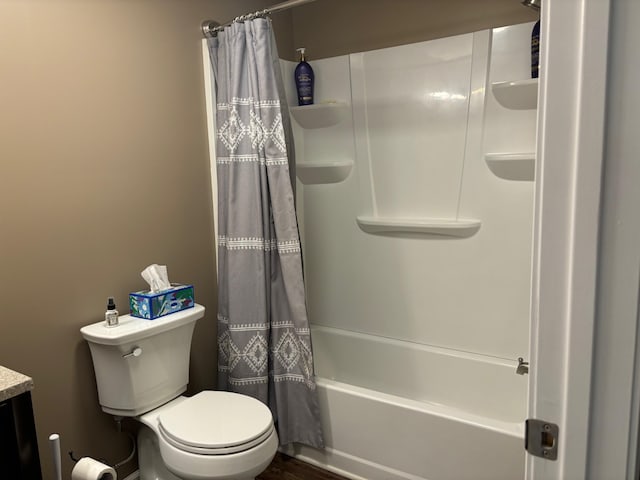 bathroom featuring shower / bath combination with curtain and toilet