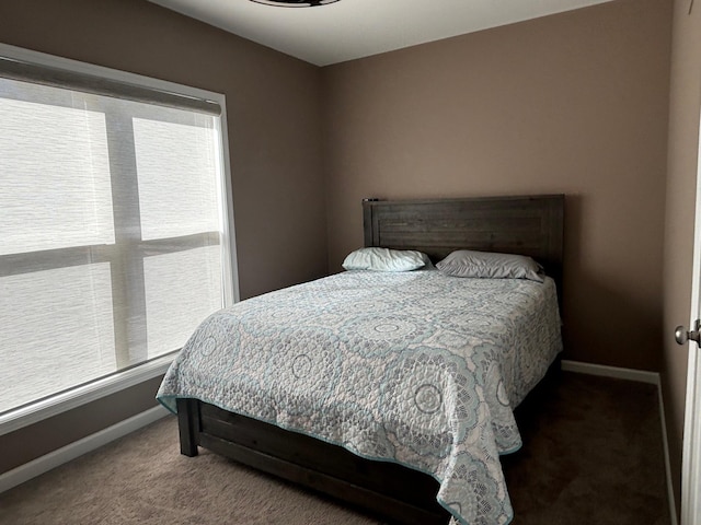 bedroom featuring carpet floors and baseboards