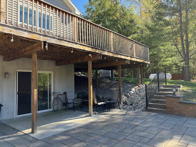 view of patio / terrace with stairway and a deck