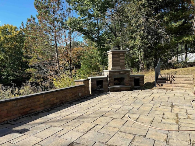 view of patio with an outdoor stone fireplace