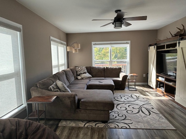 living room featuring ceiling fan and wood finished floors