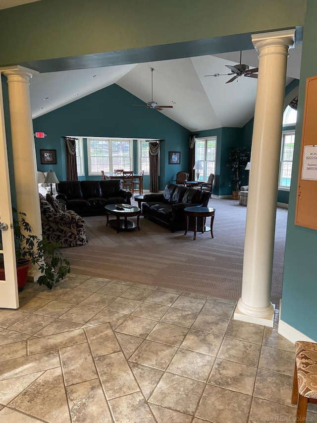 living area with decorative columns and a ceiling fan