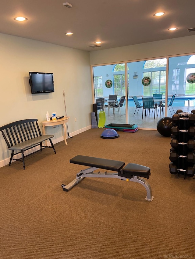 gym with baseboards and recessed lighting