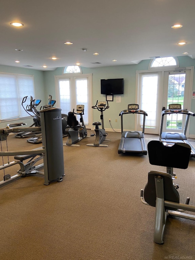 gym with baseboards, french doors, recessed lighting, and a healthy amount of sunlight