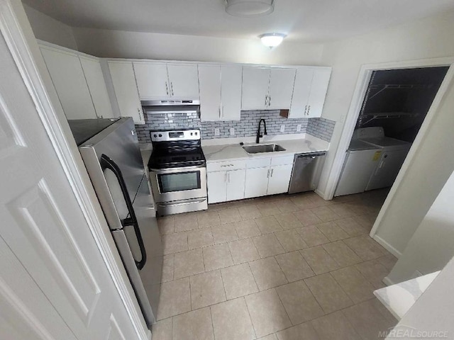 kitchen featuring white cabinets, appliances with stainless steel finishes, light countertops, under cabinet range hood, and a sink