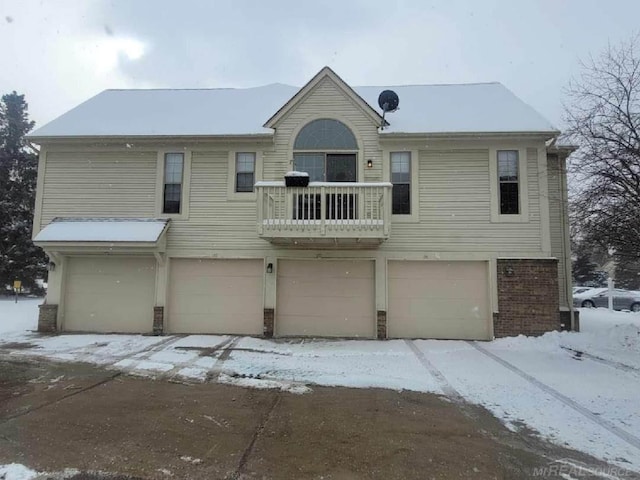 view of front facade with brick siding and an attached garage