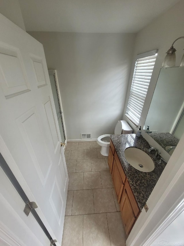 full bathroom with a shower, visible vents, toilet, vanity, and tile patterned flooring