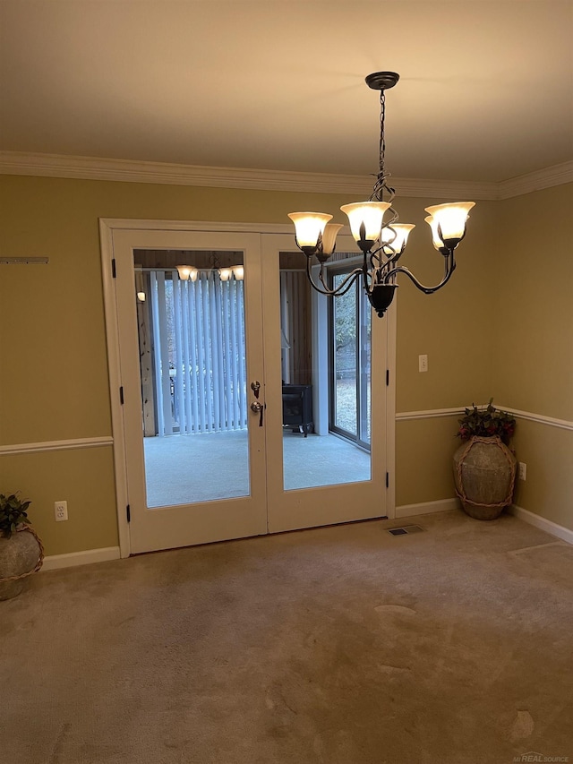 doorway to outside with a chandelier, visible vents, french doors, carpet, and crown molding